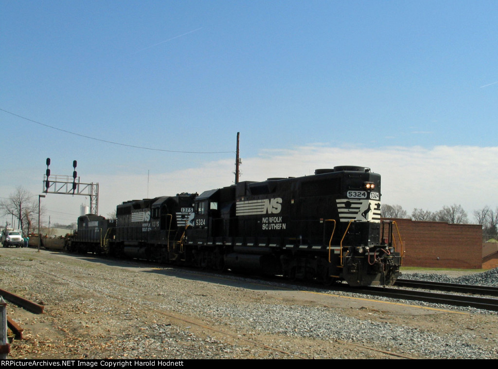 NS 5324 leads a train past the station